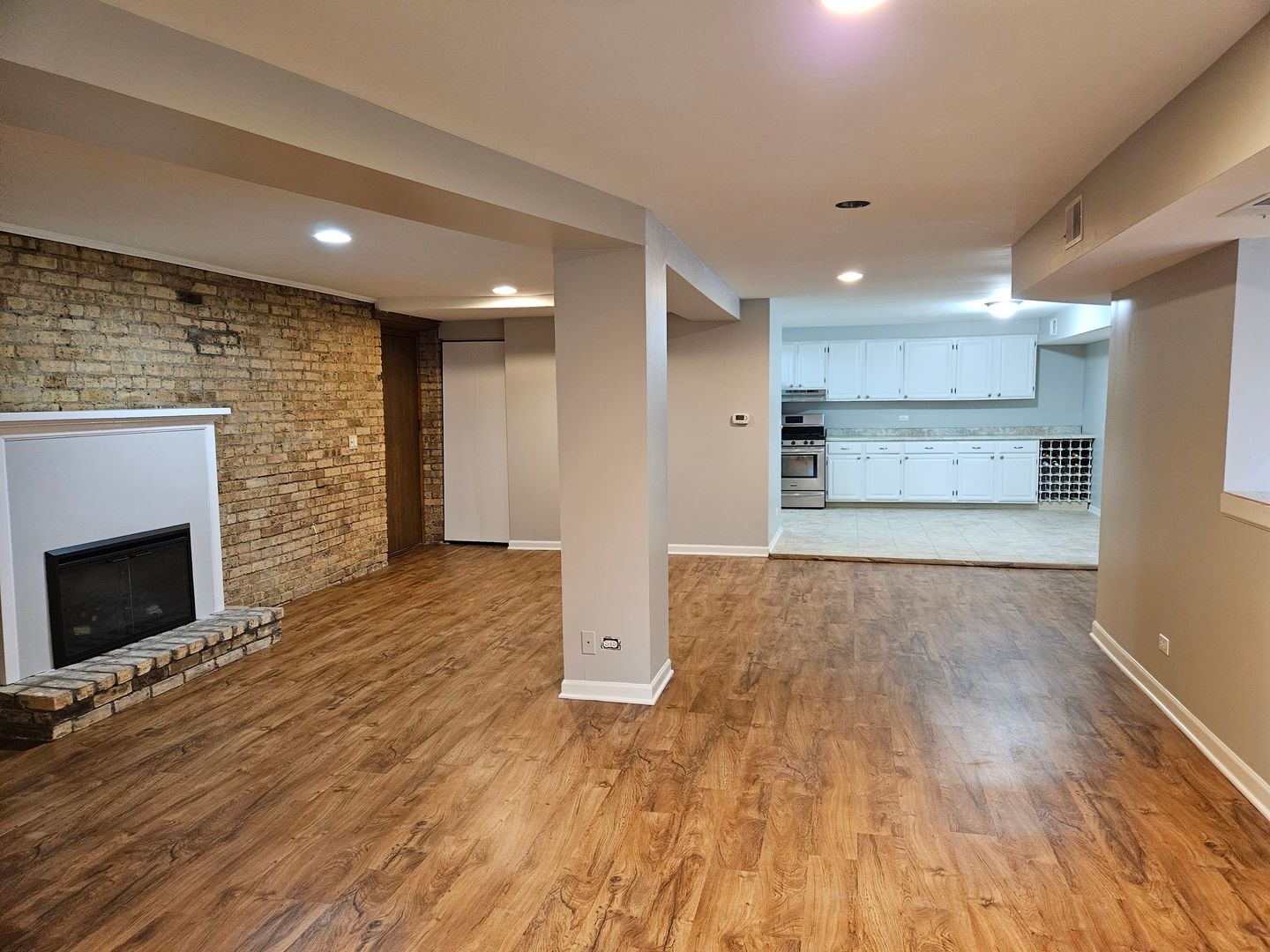 4012 North Sheridan Road, Unit GN Chicago, IL 60613 - Photo 3 of 13 a view of empty room with a fireplace and wooden floor