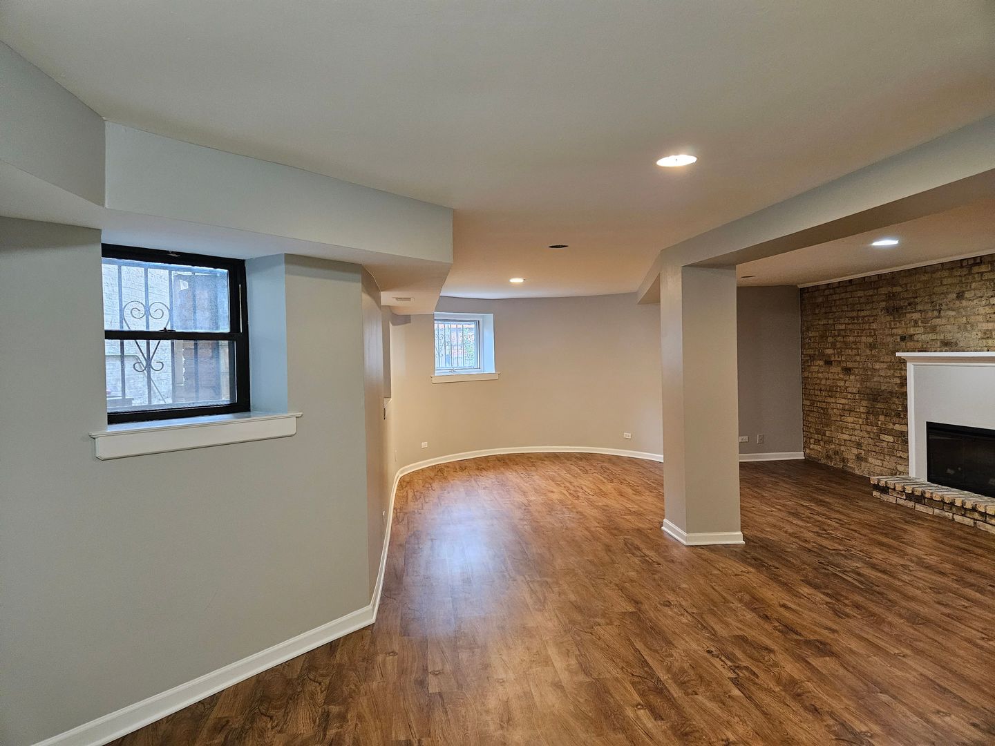 4012 North Sheridan Road, Unit GN Chicago, IL 60613 - Photo 4 of 13 wooden floor in an empty room with a window