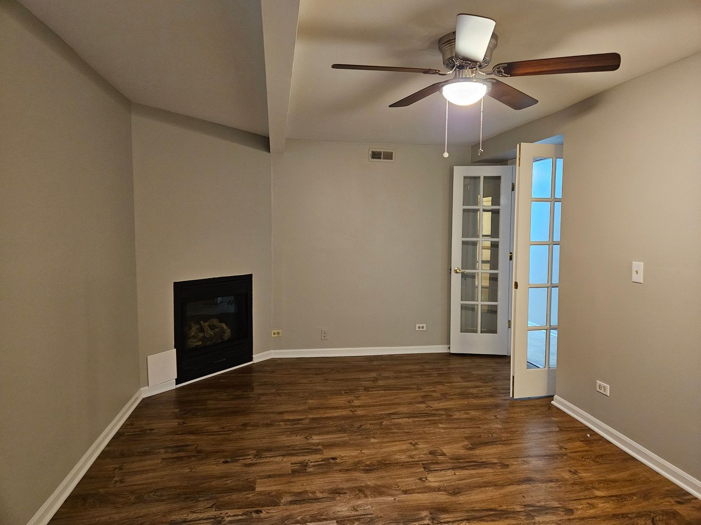 4012 North Sheridan Road, Unit GN Chicago, IL 60613 - Photo 9 of 13 a view of an empty room with window and wooden floor