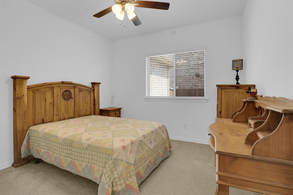 1446 Whitewater Drive Little Elm, TX 75068 - Photo 13 of 35 a bedroom with a bed and wooden floor