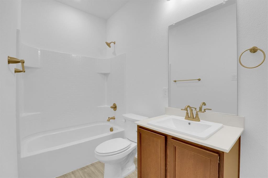 1446 Whitewater Drive Little Elm, TX 75068 - Photo 15 of 35 a bathroom with a sink toilet and a bathtub