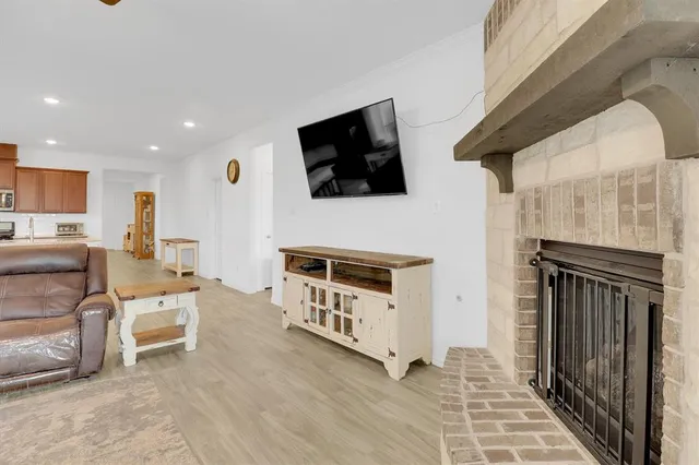 a living room with furniture kitchen view and a chandelier