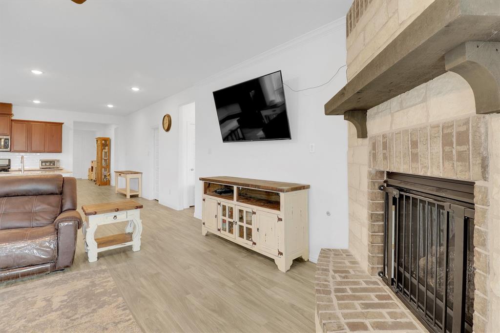1446 Whitewater Drive Little Elm, TX 75068 - Photo 24 of 35 a living room with furniture and a flat screen tv