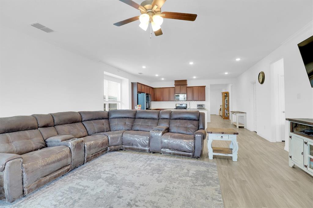 1446 Whitewater Drive Little Elm, TX 75068 - Photo 25 of 35 a living room with furniture kitchen view and a chandelier