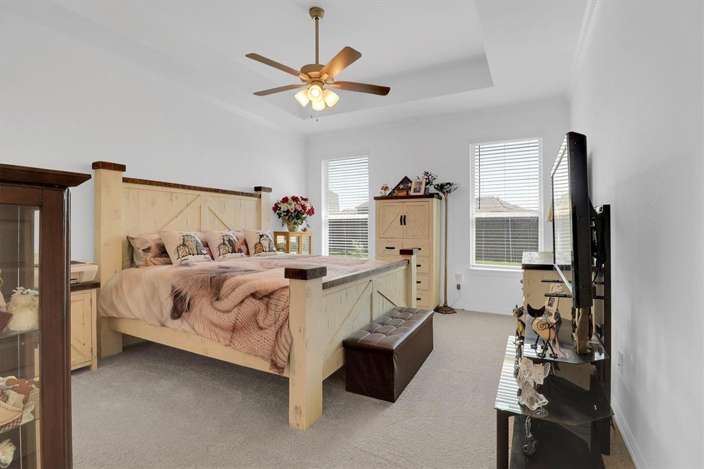 1446 Whitewater Drive Little Elm, TX 75068 - Photo 26 of 35 a bed sitting in a bedroom next to a window