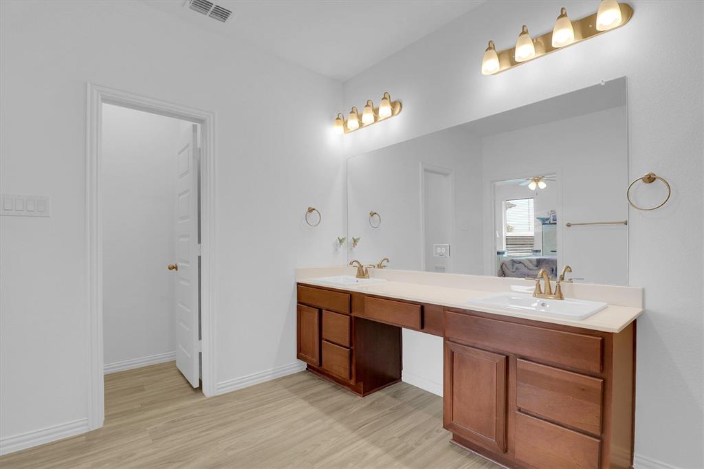 1446 Whitewater Drive Little Elm, TX 75068 - Photo 29 of 35 a bathroom with a double vanity sink and a mirror