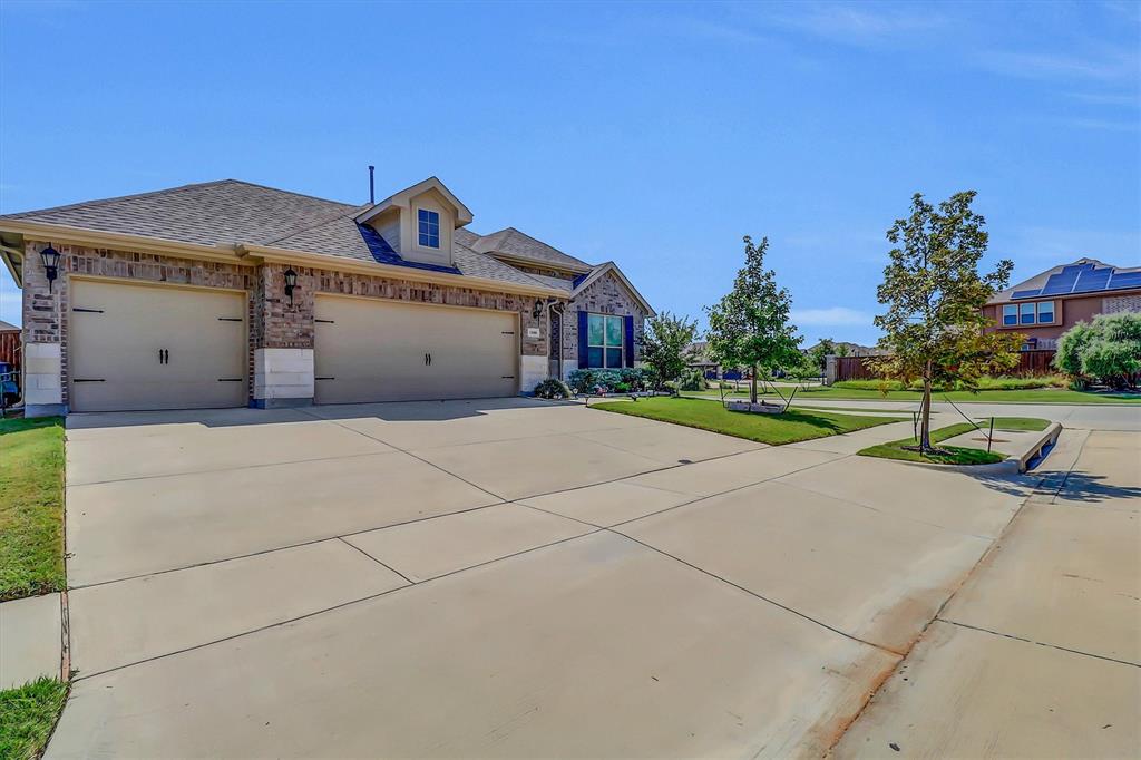 1446 Whitewater Drive Little Elm, TX 75068 - Photo 3 of 35 a front view of a house with a yard and garage