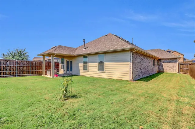 a view of a house with a yard and sitting area