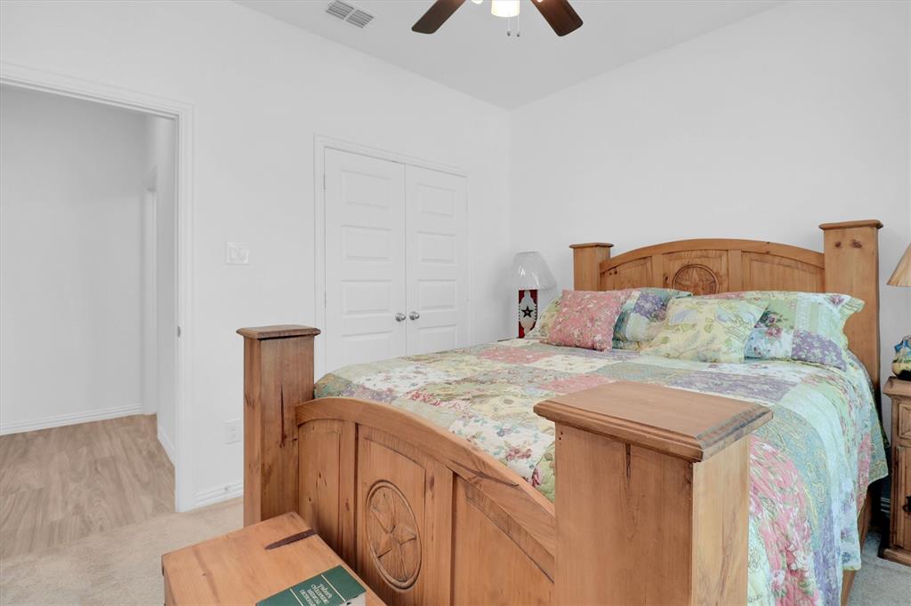 1446 Whitewater Drive Little Elm, TX 75068 - Photo 7 of 35 a bedroom with a bed and a dresser