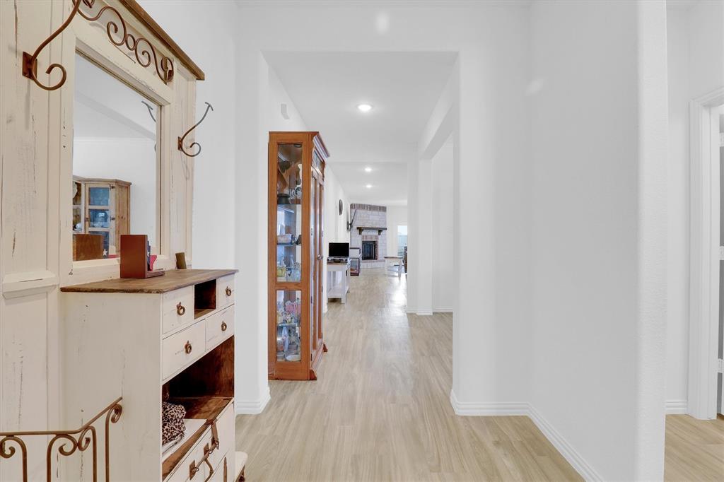 1446 Whitewater Drive Little Elm, TX 75068 - Photo 9 of 35 a hallway with wooden floor and staircase
