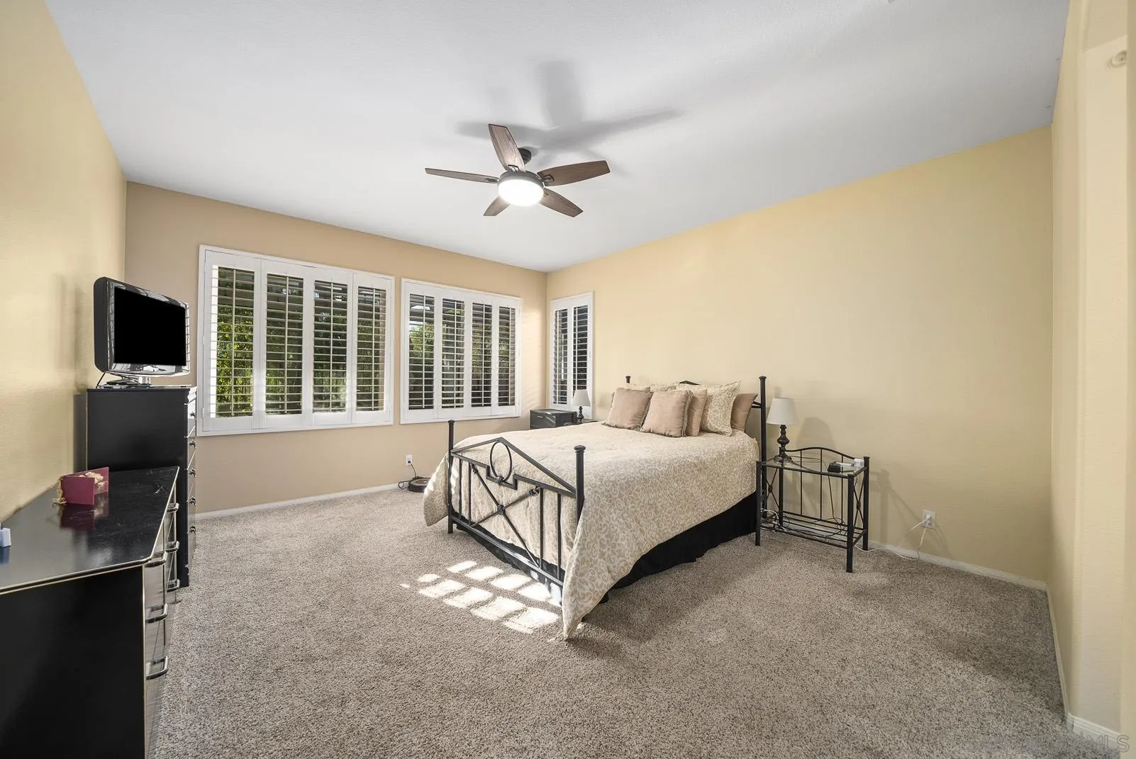 41453 Temeku Drive Temecula, CA 92591 - Photo 15 of 34 a spacious bedroom with a bed and tv