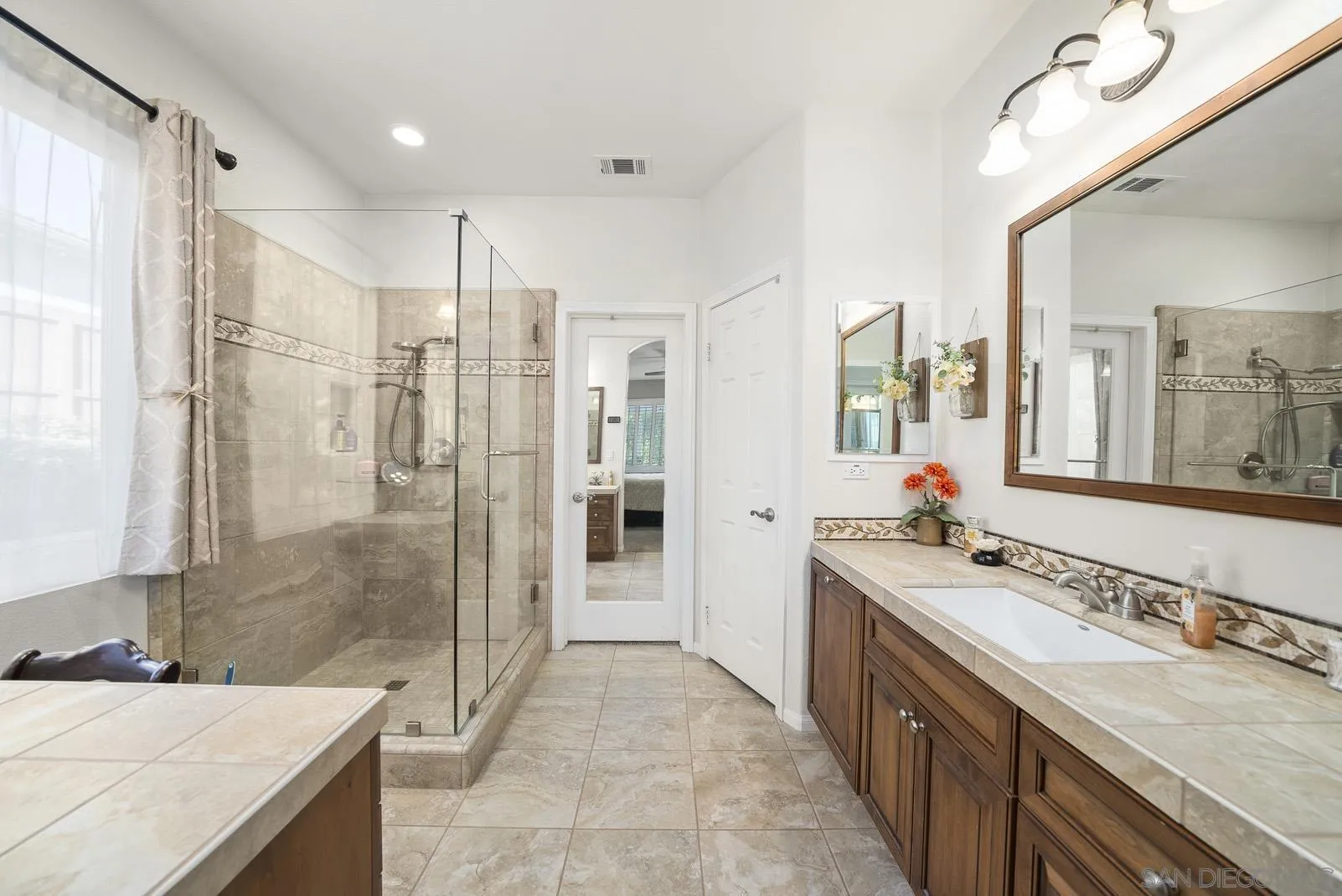 41453 Temeku Drive Temecula, CA 92591 - Photo 18 of 34 a spacious bathroom with a granite countertop sink mirror and shower