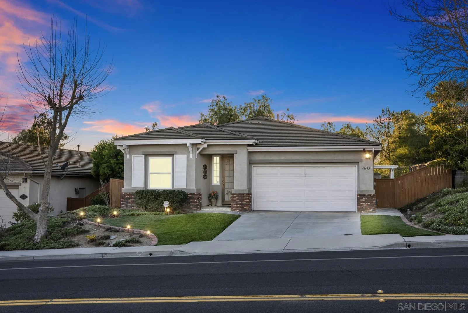 41453 Temeku Drive Temecula, CA 92591 - Photo 27 of 34 a front view of a house with a yard garage and outdoor seating