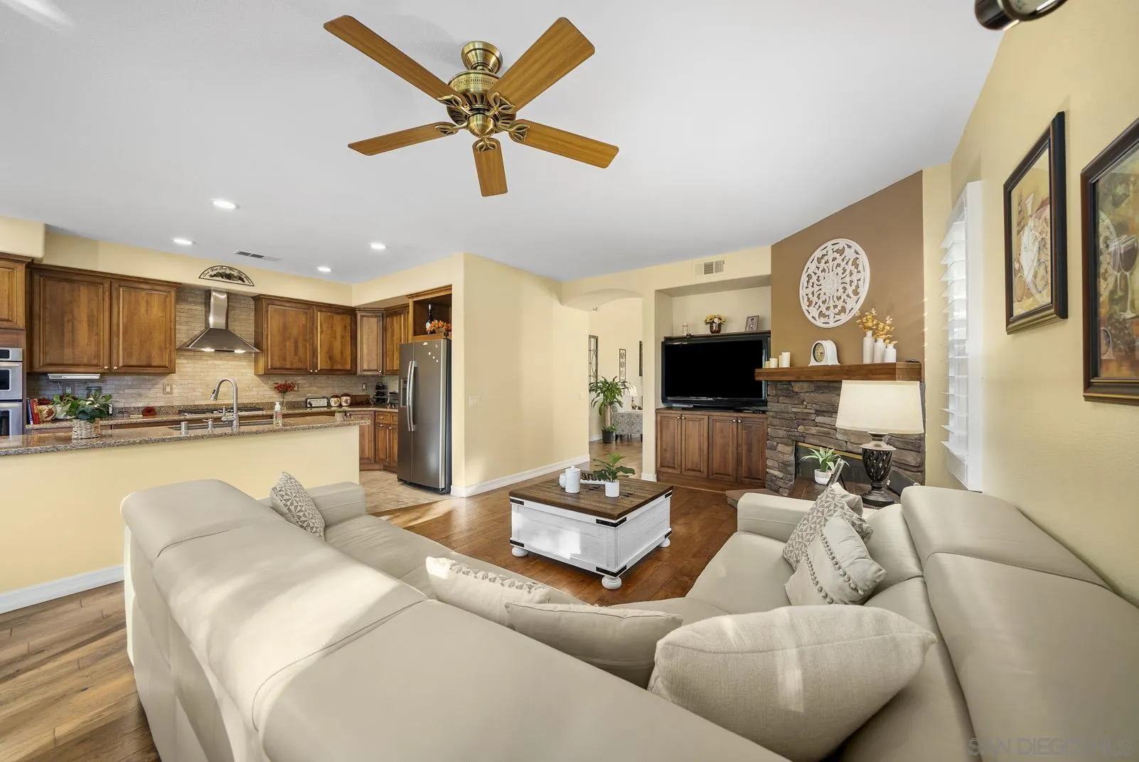 41453 Temeku Drive Temecula, CA 92591 - Photo 3 of 34 a living room with furniture kitchen view and a flat screen tv