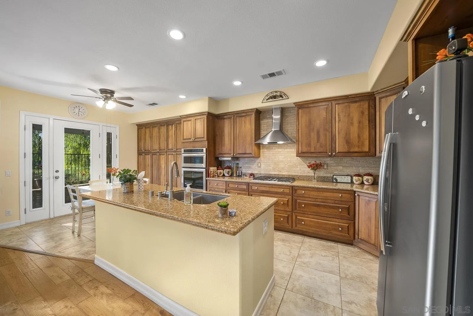 41453 Temeku Drive Temecula, CA 92591 - Photo 8 of 34 a kitchen with stainless steel appliances granite countertop a sink stove and refrigerator