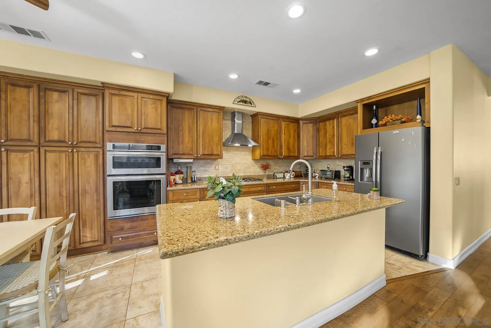 41453 Temeku Drive Temecula, CA 92591 - Photo 9 of 34 a large kitchen with kitchen island a large counter top stainless steel appliances and cabinets