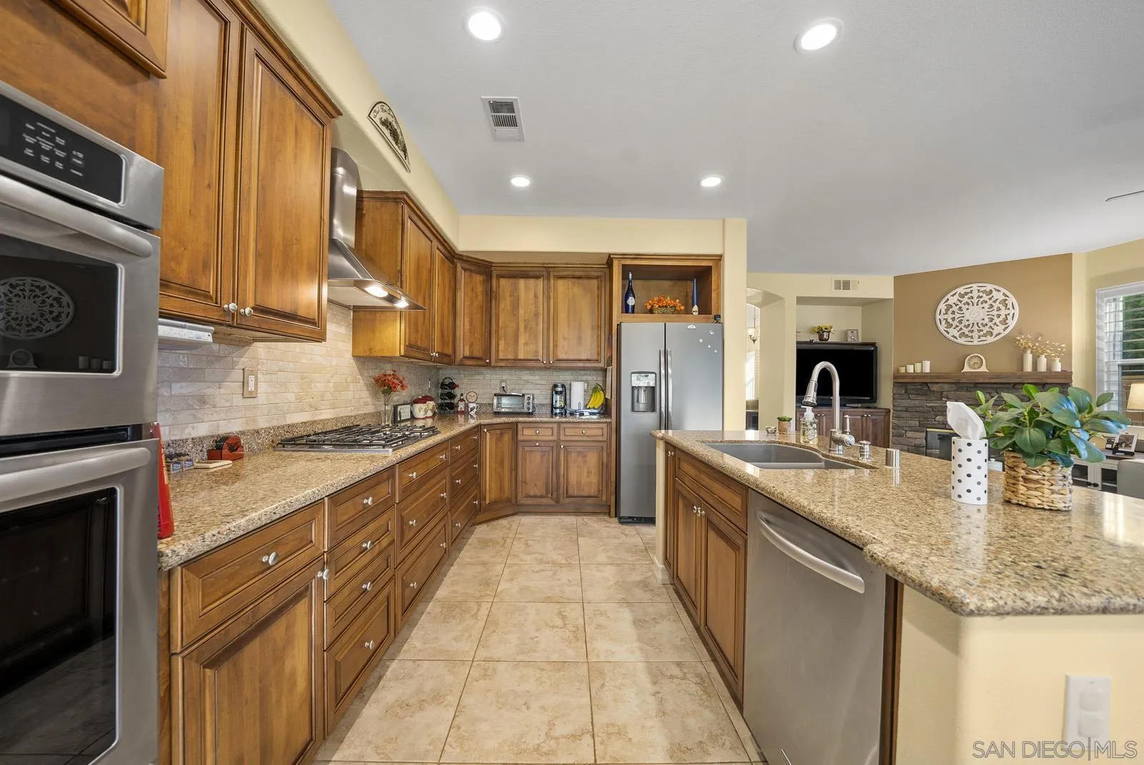 41453 Temeku Drive Temecula, CA 92591 - Photo 10 of 34 a large kitchen with stainless steel appliances granite countertop a sink stove and cabinets