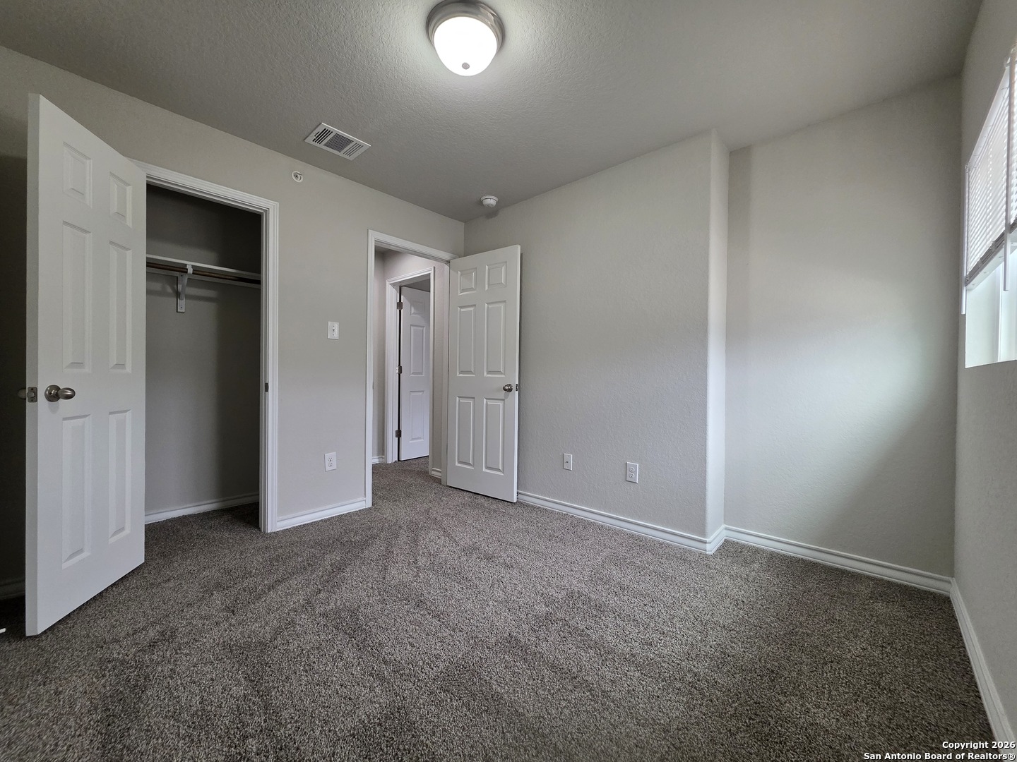 16909 Dancing Ava, Unit 2 Selma, TX 78154 - Photo 14 of 22 an empty room with closet and windows