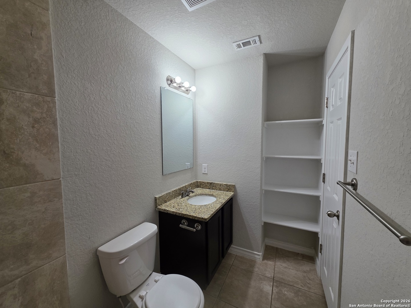 16909 Dancing Ava, Unit 2 Selma, TX 78154 - Photo 17 of 22 a bathroom with a toilet sink and mirror