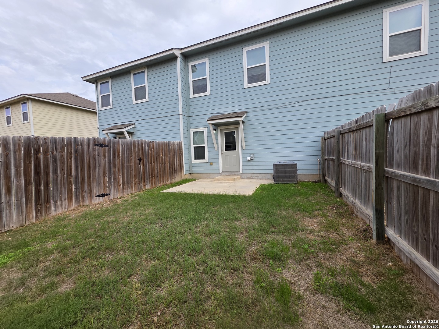 16909 Dancing Ava, Unit 2 Selma, TX 78154 - Photo 20 of 22 a front view of house with yard and green space
