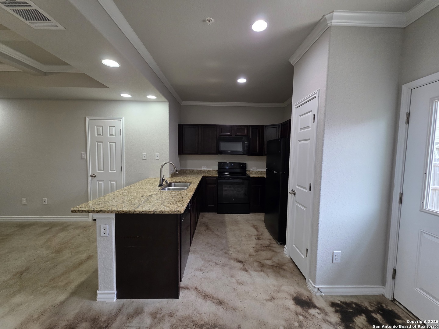 16909 Dancing Ava, Unit 2 Selma, TX 78154 - Photo 5 of 22 a kitchen with a sink a refrigerator and cabinets