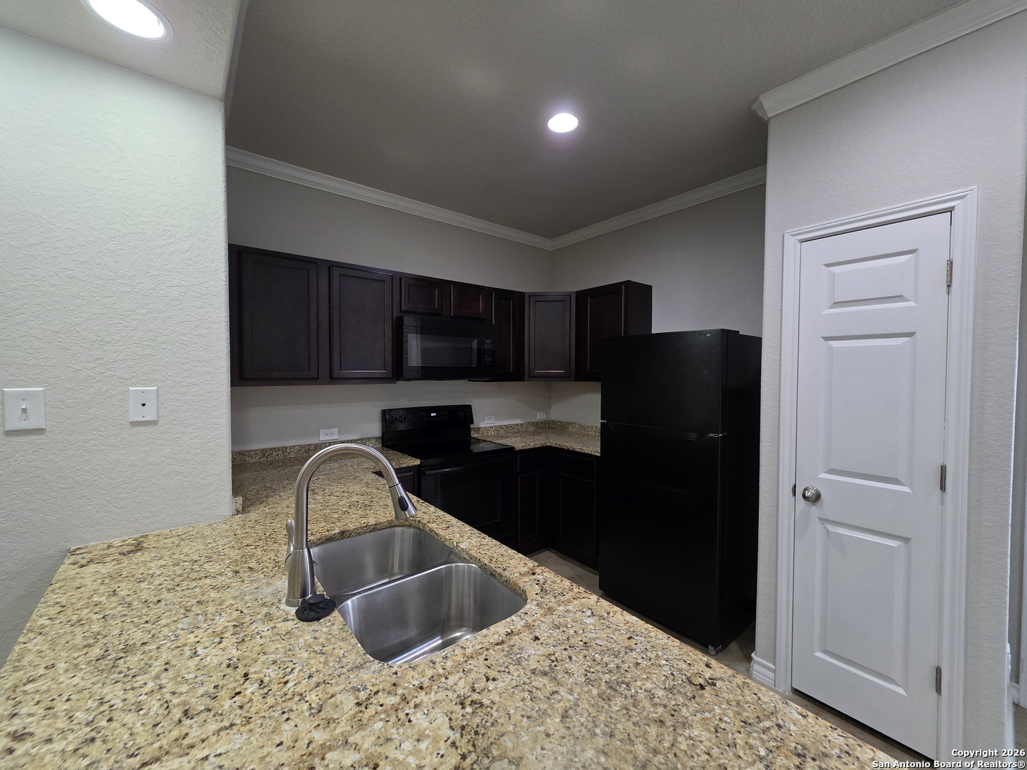 16909 Dancing Ava, Unit 2 Selma, TX 78154 - Photo 6 of 22 a kitchen with a sink and a refrigerator