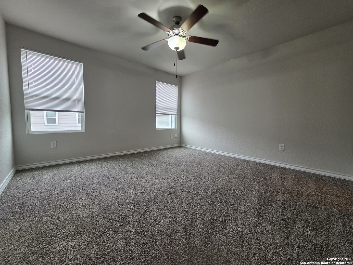 16909 Dancing Ava, Unit 2 Selma, TX 78154 - Photo 7 of 22 an empty room with a window and a fan