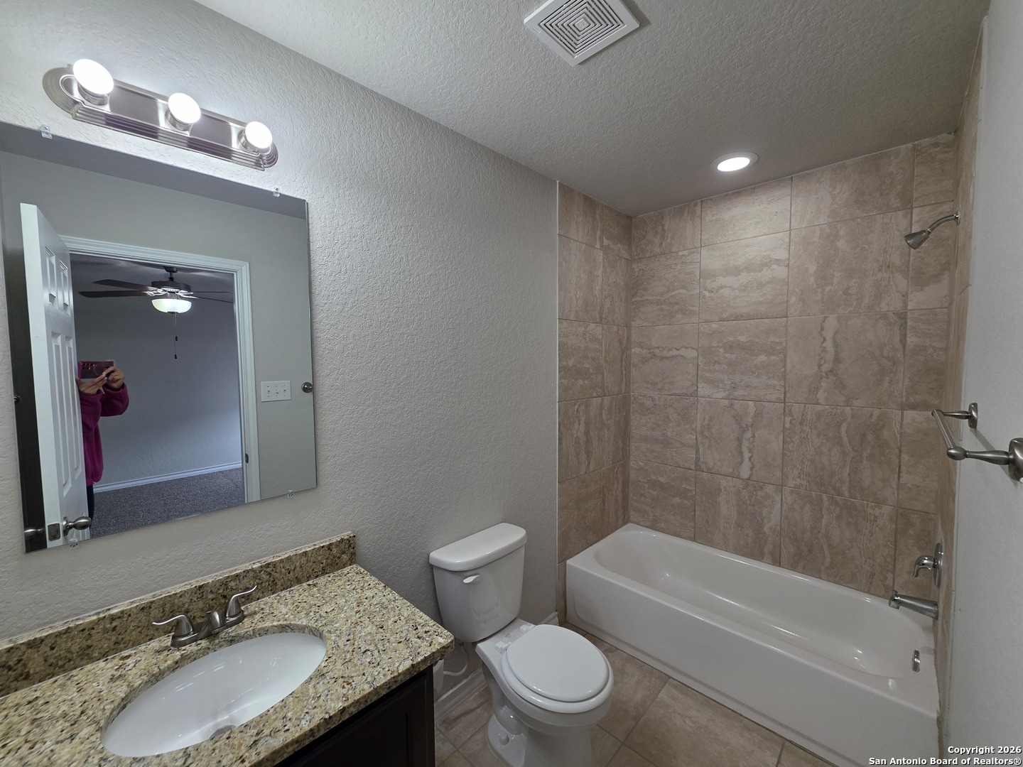 16909 Dancing Ava, Unit 2 Selma, TX 78154 - Photo 10 of 22 a bathroom with a granite countertop sink toilet mirror and bathtub
