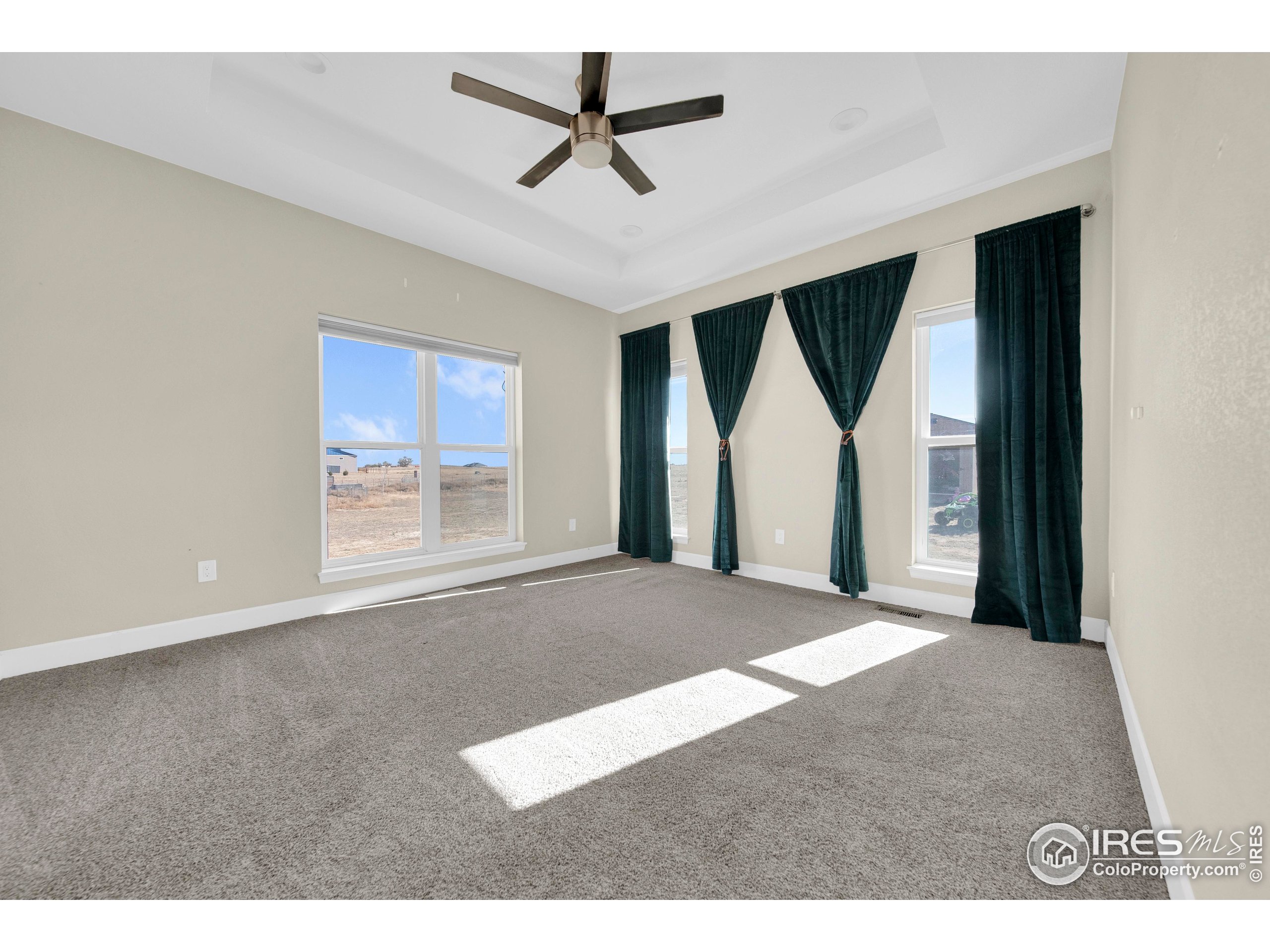 7566 County Road Wiggins, CO 80654 - Photo 11 of 23 a view of a livingroom with a ceiling fan and window