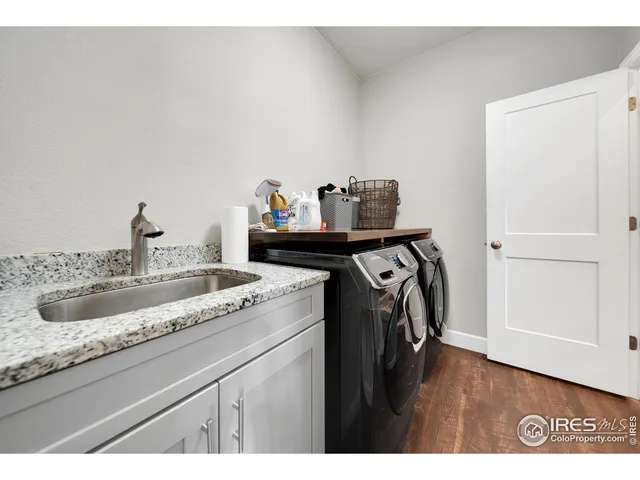 a utility room with a sink dryer and washer