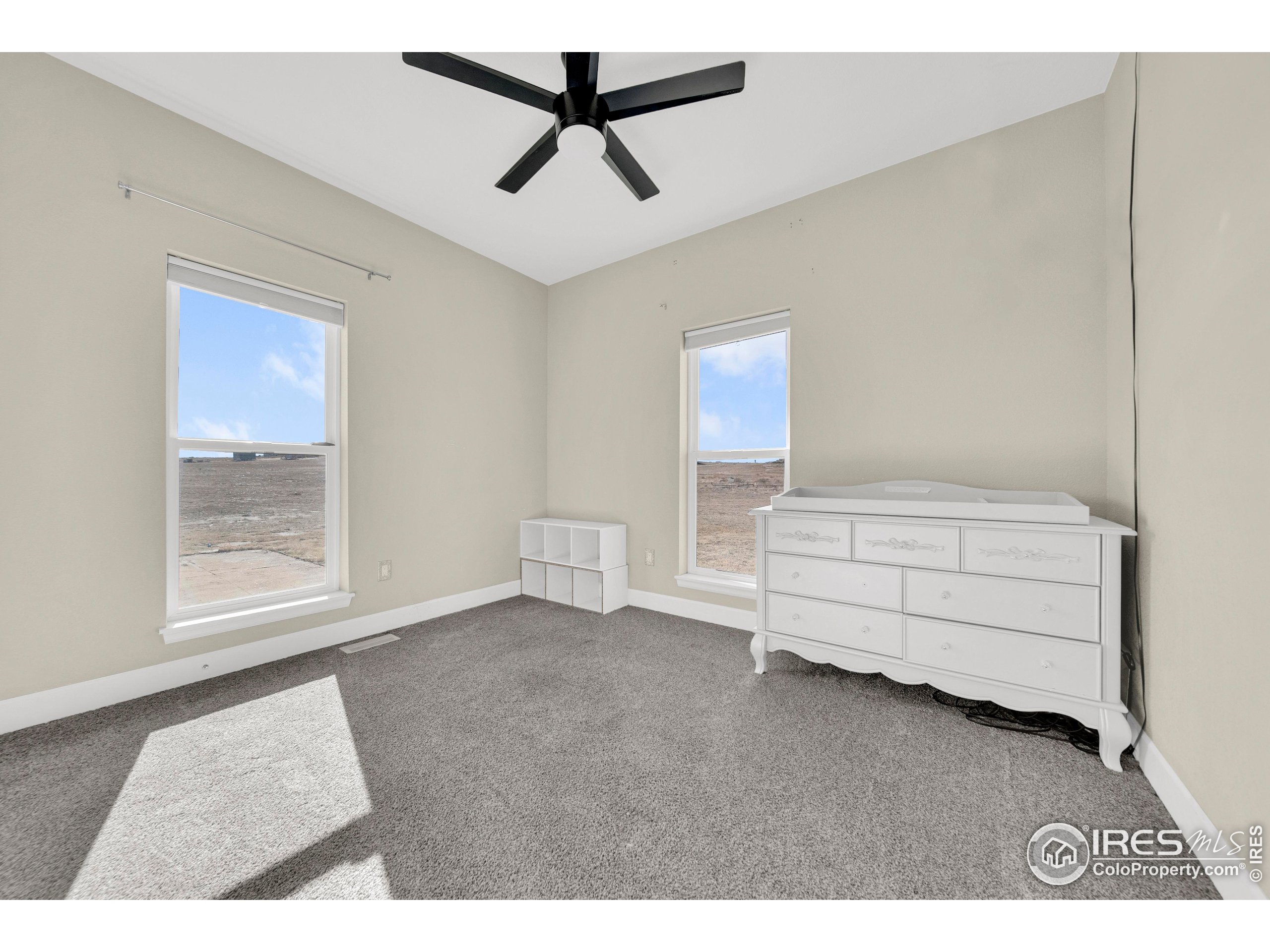 7566 County Road Wiggins, CO 80654 - Photo 15 of 23 a bedroom with a bed and a window