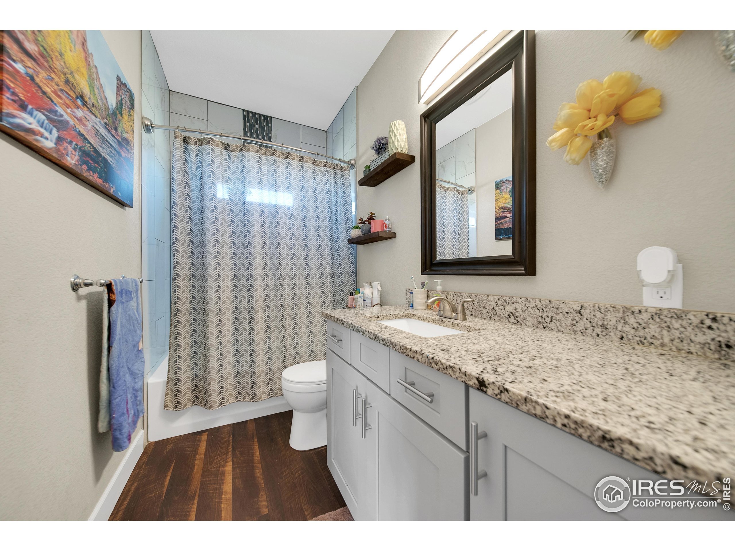 7566 County Road Wiggins, CO 80654 - Photo 17 of 23 a bathroom with a granite countertop sink toilet and shower