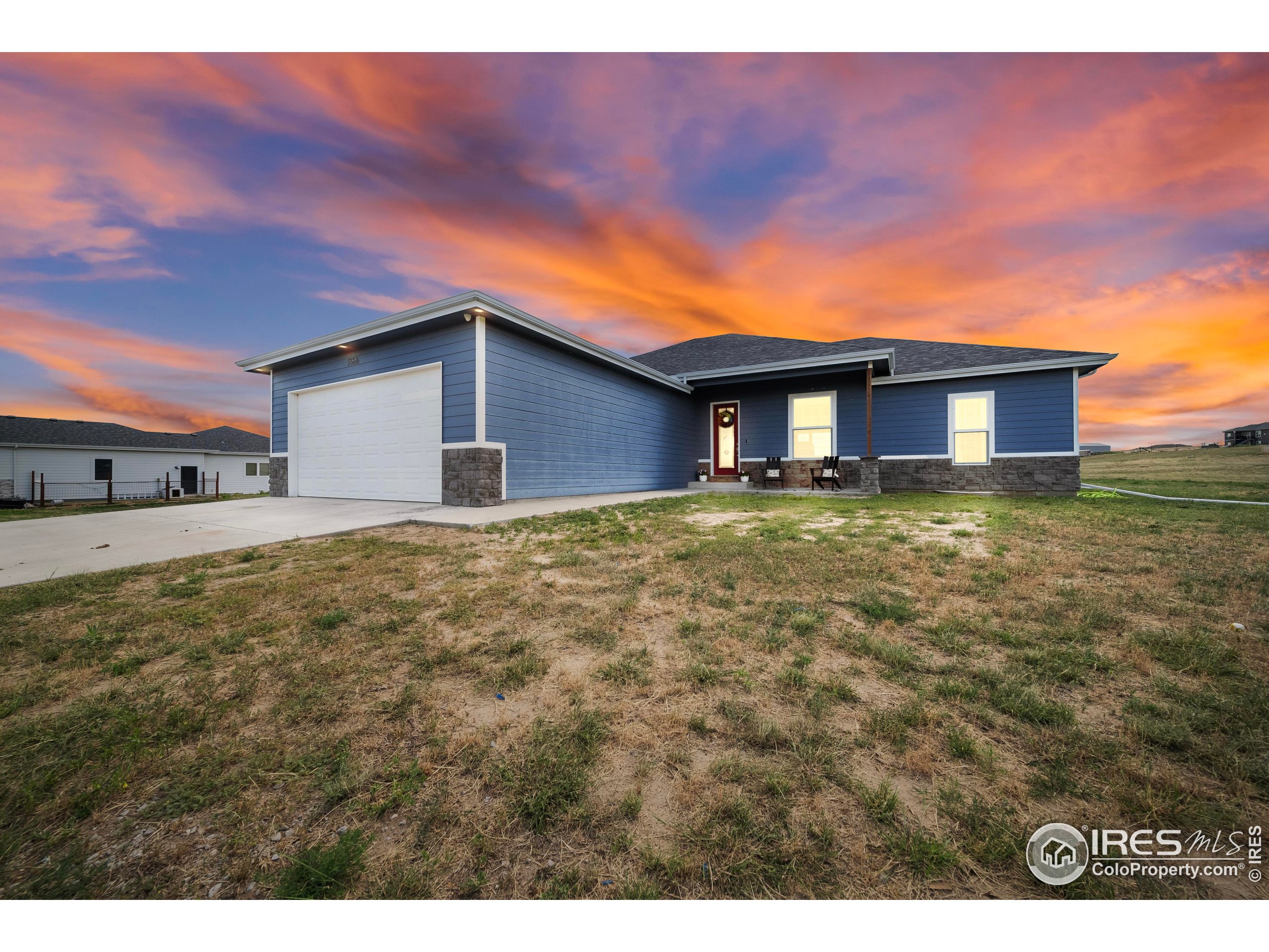 7566 County Road Wiggins, CO 80654 - Photo 2 of 23 a house view with a garden space