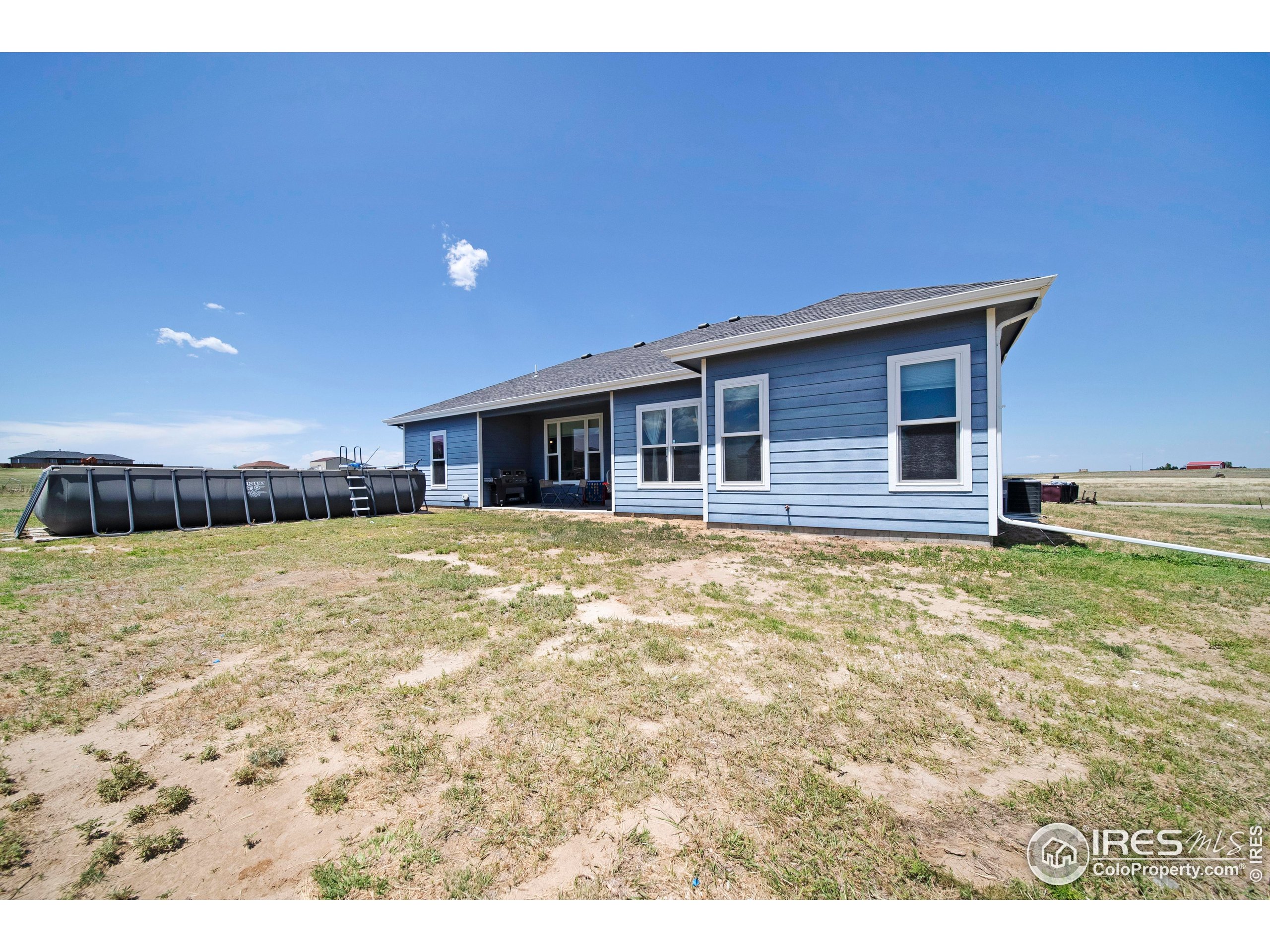 7566 County Road Wiggins, CO 80654 - Photo 22 of 23 a house view with a garden space