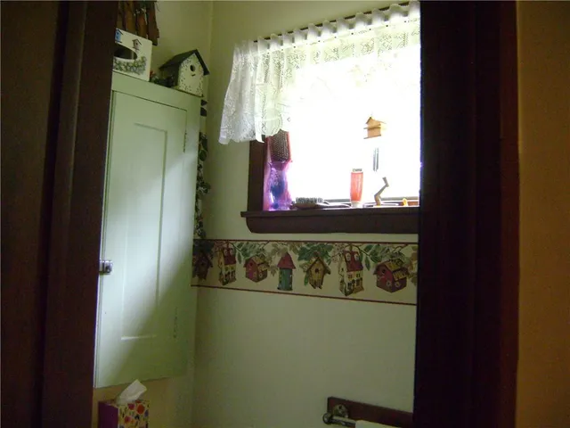 a bedroom with bed and a window