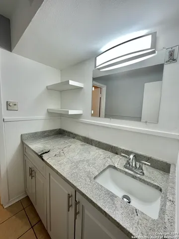 a white toilet sitting next to a bath tub and shower