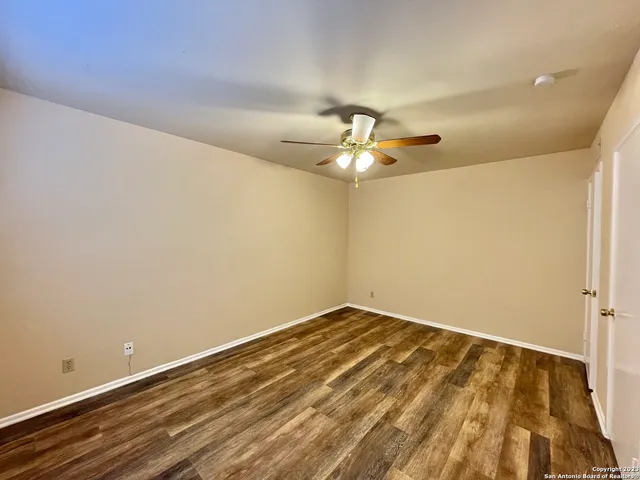 a view of a room with a ceiling fan and a window
