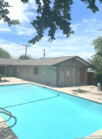 a swimming pool with trees in the background