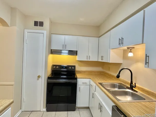 a kitchen with a refrigerator and a sink