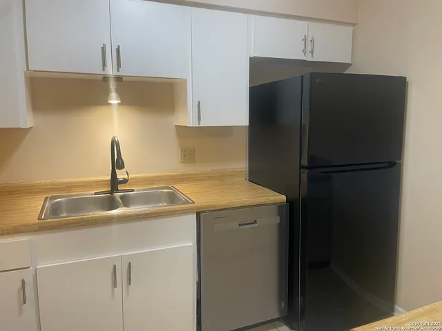 a kitchen with a sink and cabinets