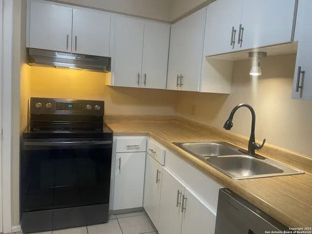 a kitchen with sink and cabinets