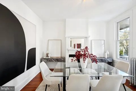 a dining room with furniture and window
