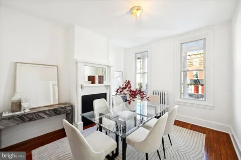 a living room with furniture a window and a flat screen tv