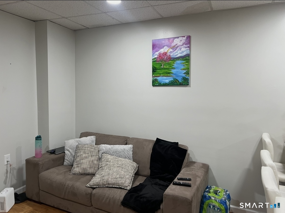 391 Coleman Street Bridgeport, CT 06604 - Photo 11 of 13 a living room with furniture and a couch