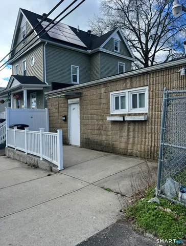a kitchen with a table chairs refrigerator and cabinets