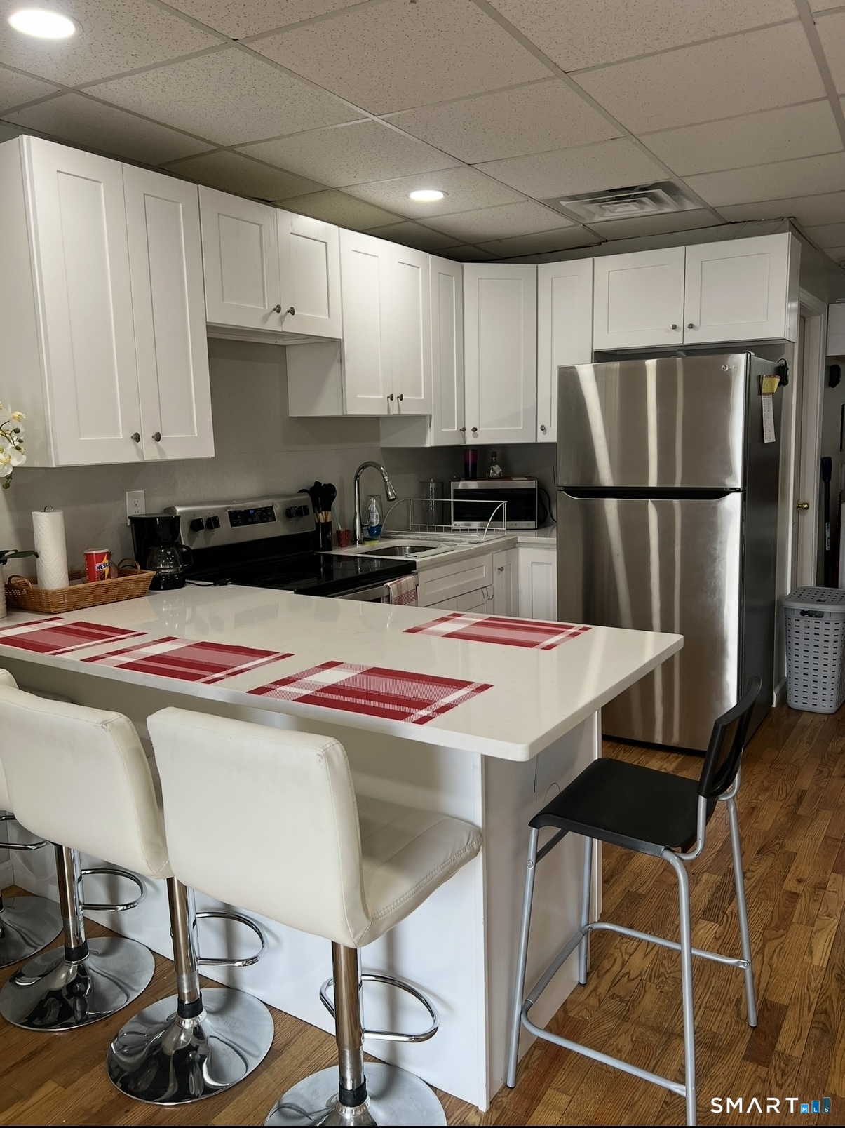 391 Coleman Street Bridgeport, CT 06604 - Photo 9 of 13 a kitchen with a table chairs refrigerator and cabinets