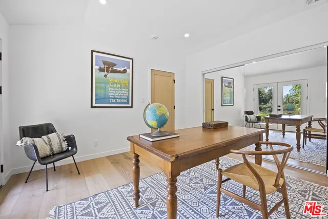 a view of entryway and kitchen with wooden floor