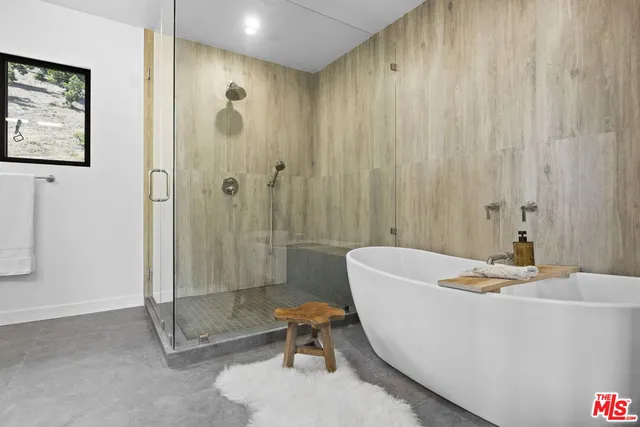 a spacious bedroom with a bed and a dresser