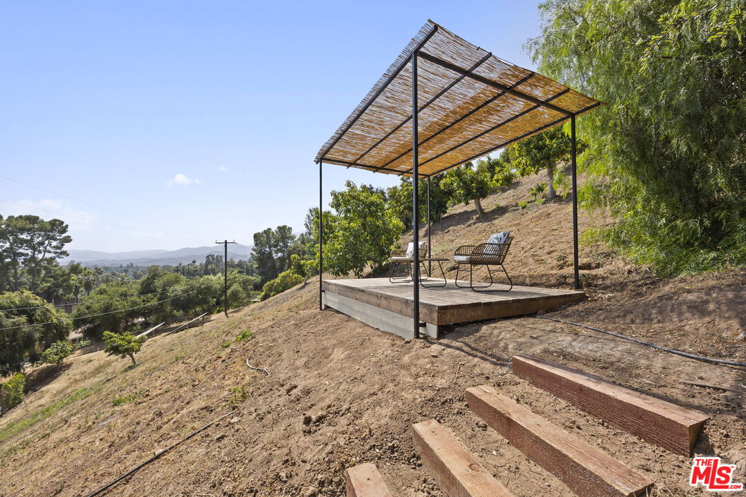 1131 Rancho Drive Ojai, CA 93023 - Photo 55 of 58 a wooden bench sitting in the middle of a yard