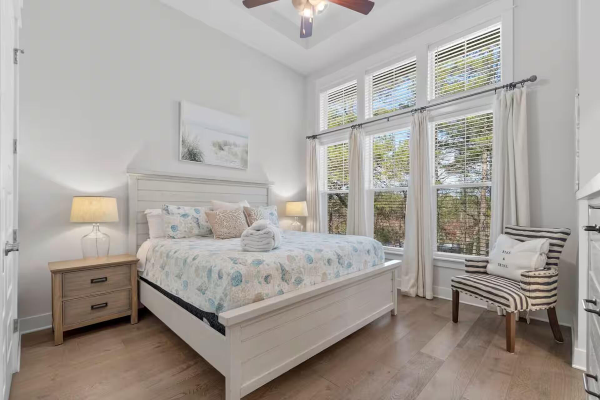 146 East E Pine, Unit B Inlet Beach, FL 32461 - Photo 19 of 47 a bedroom with a bed and a chandelier fan